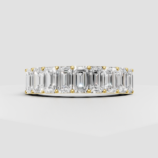 Emerald cut diamond eternity ring in polished yellow gold