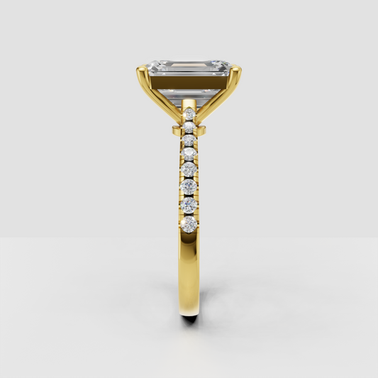 Elongated emerald cut diamond ring with pavé shoulders