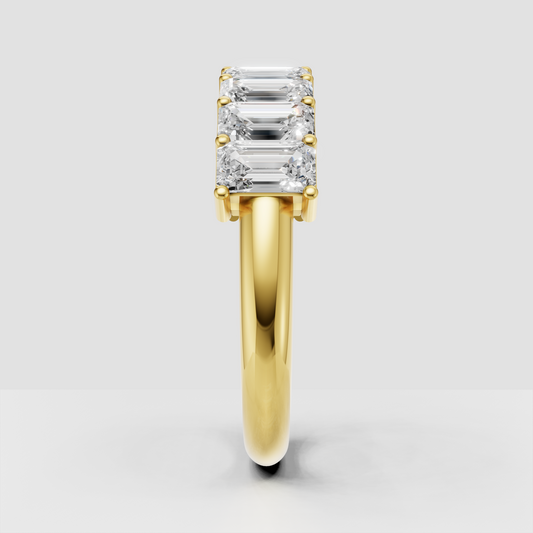Yellow gold emerald cut eternity ring with elongated stones