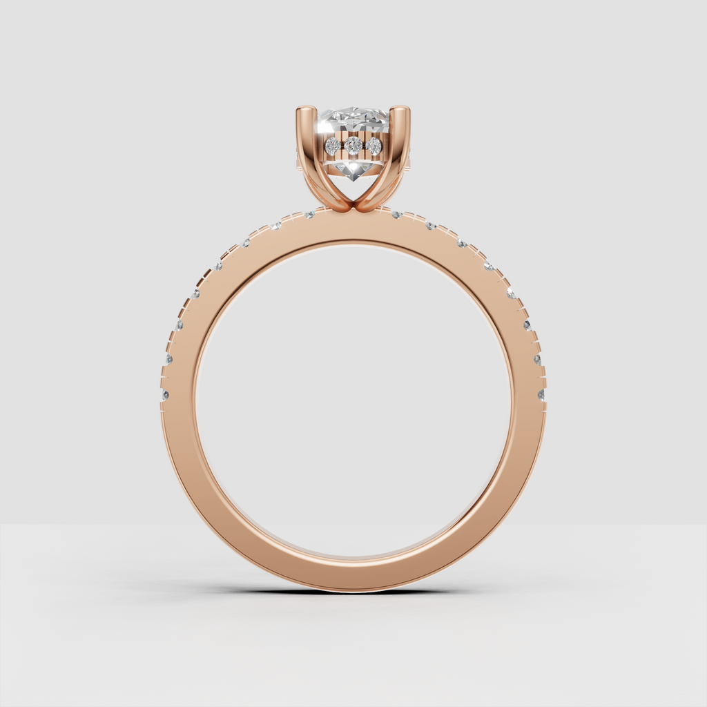 Modern oval diamond engagement jewelry featuring a polished gold band and discreet under-gallery halo.