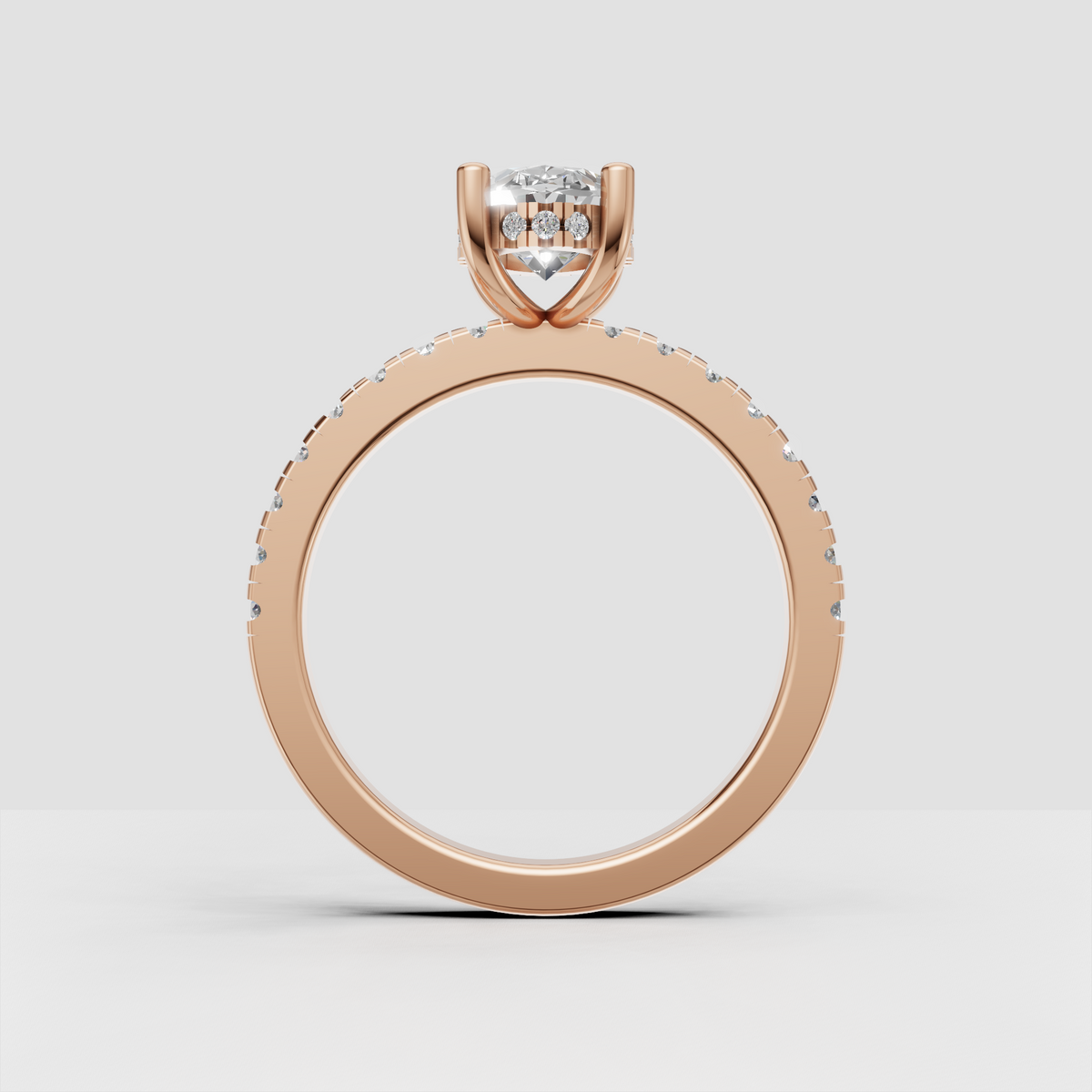 Modern oval diamond engagement jewelry featuring a polished gold band and discreet under-gallery halo.