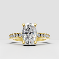Oval diamond engagement ring with four-prong setting and hidden halo in polished gold.
