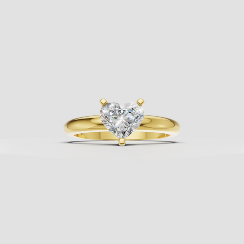 Heart-shaped diamond three-prong solitaire engagement ring in polished white metal
