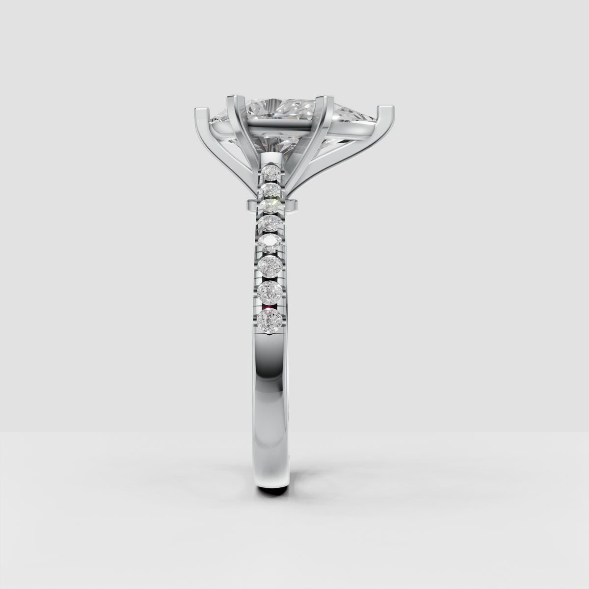 Modern pear-shaped diamond ring with sculpted cathedral setting and polished metal