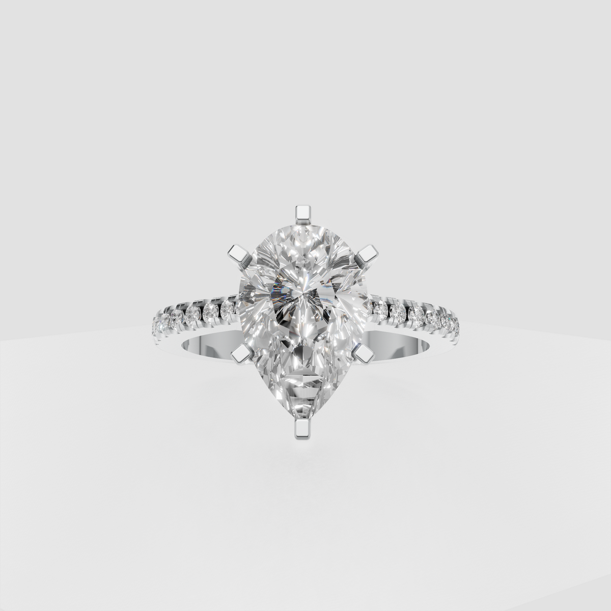 Pear-shaped center diamond ring with secure multi-prong setting and tapered band