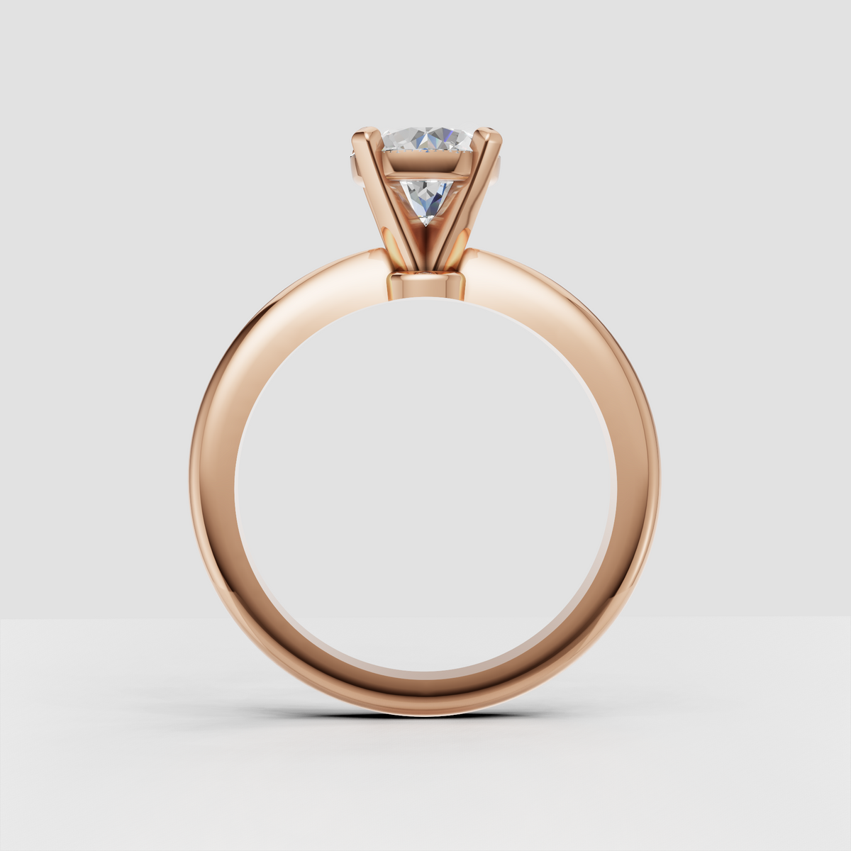 Round diamond ring side view showing raised basket setting and streamlined split-shank band