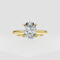Oval diamond solitaire engagement ring with polished yellow gold band and four-prong setting