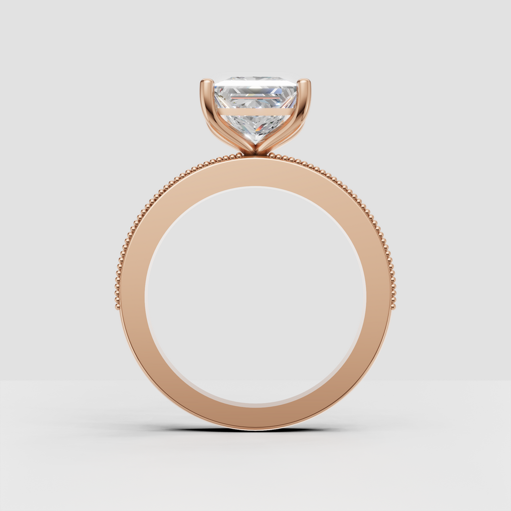 Square princess-cut diamond ring with four rounded prongs and ornate band accents