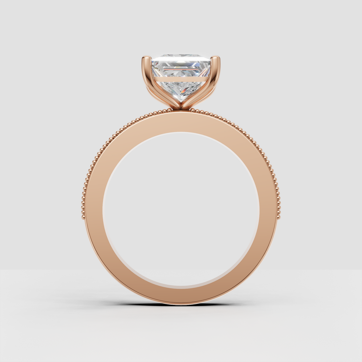 Square princess-cut diamond ring with four rounded prongs and ornate band accents
