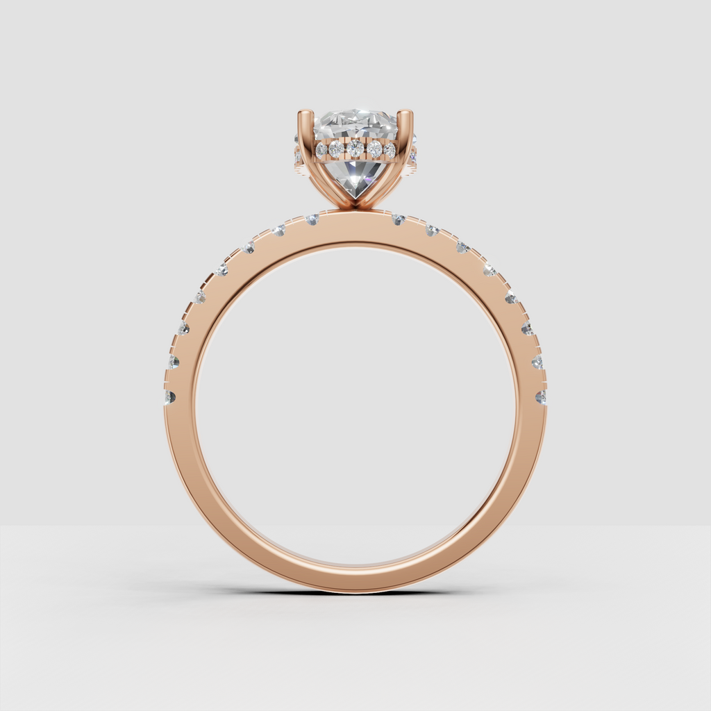 Perspective view of pear shaped diamond ring with detailed pavé shoulders