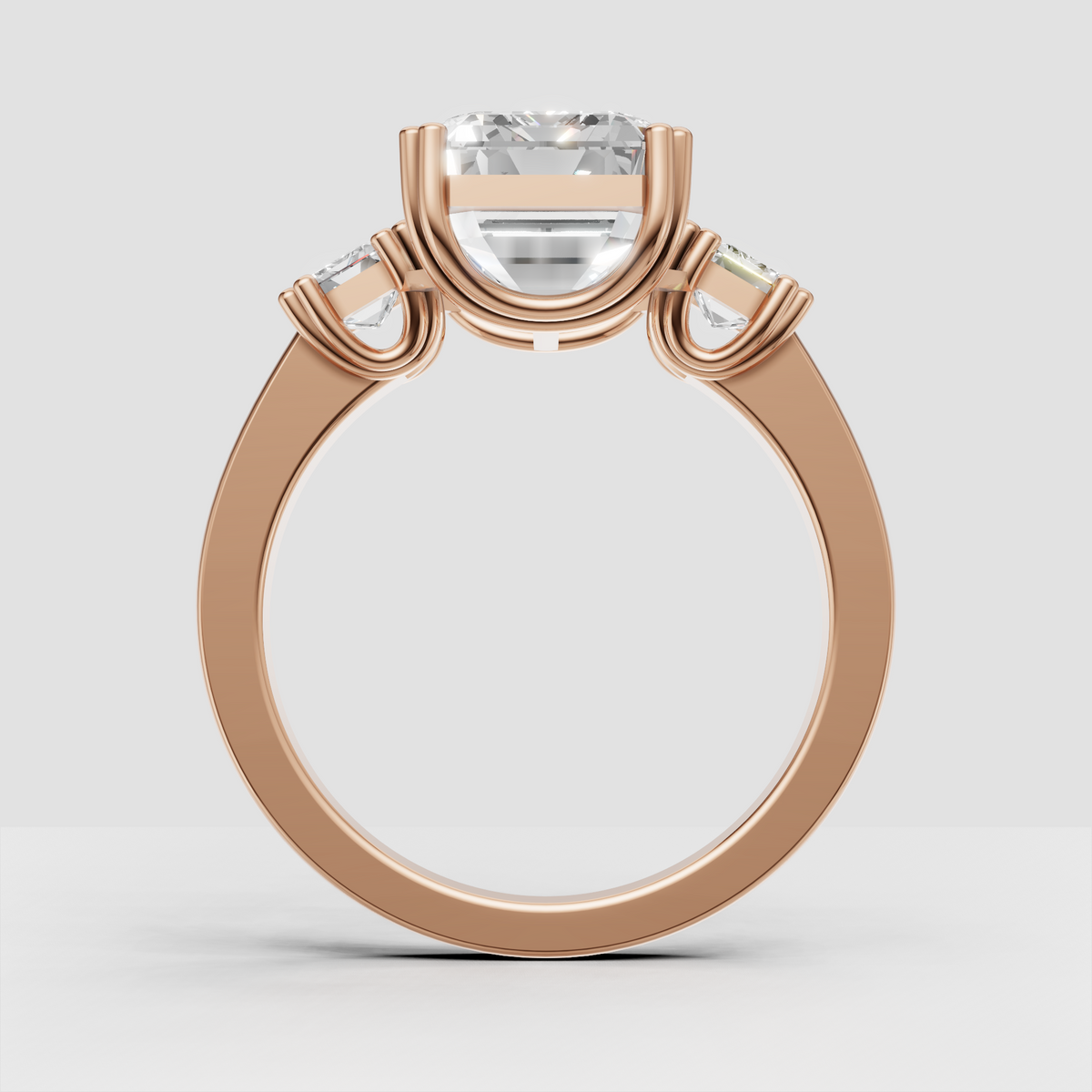 Yellow gold engagement ring featuring three emerald cut stones