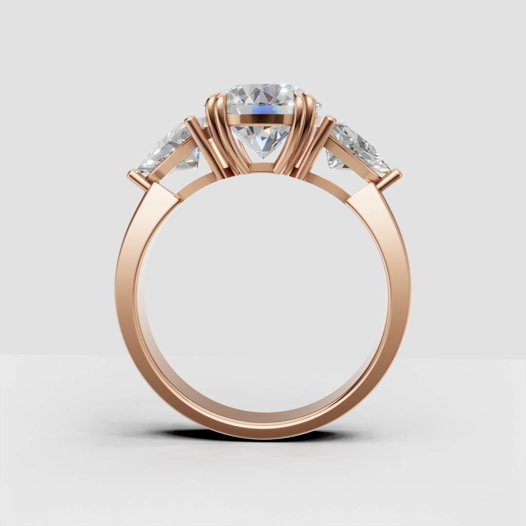 Timeless round centre diamond engagement ring with pear side stones