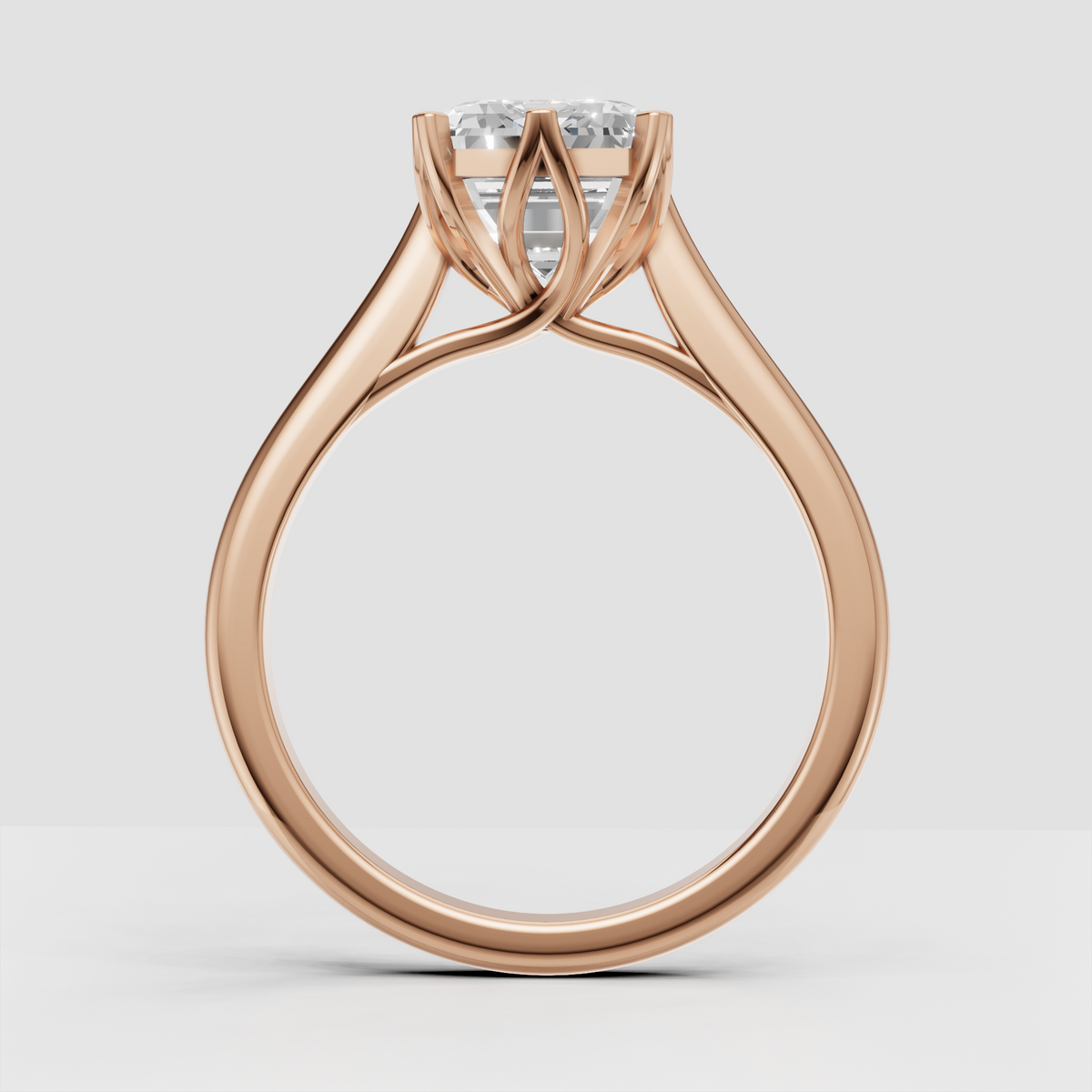 Emerald cut diamond bridal ring with open crossover gallery design