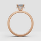 Polished yellow gold ring featuring an oval diamond center stone