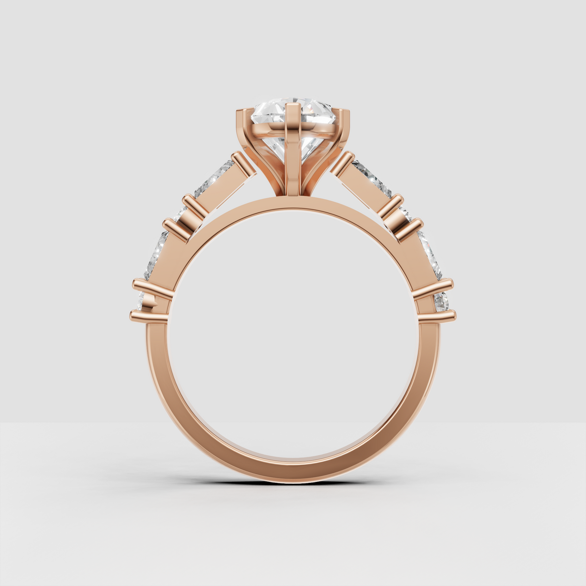 Six-prong pear cut engagement ring with baguette accents