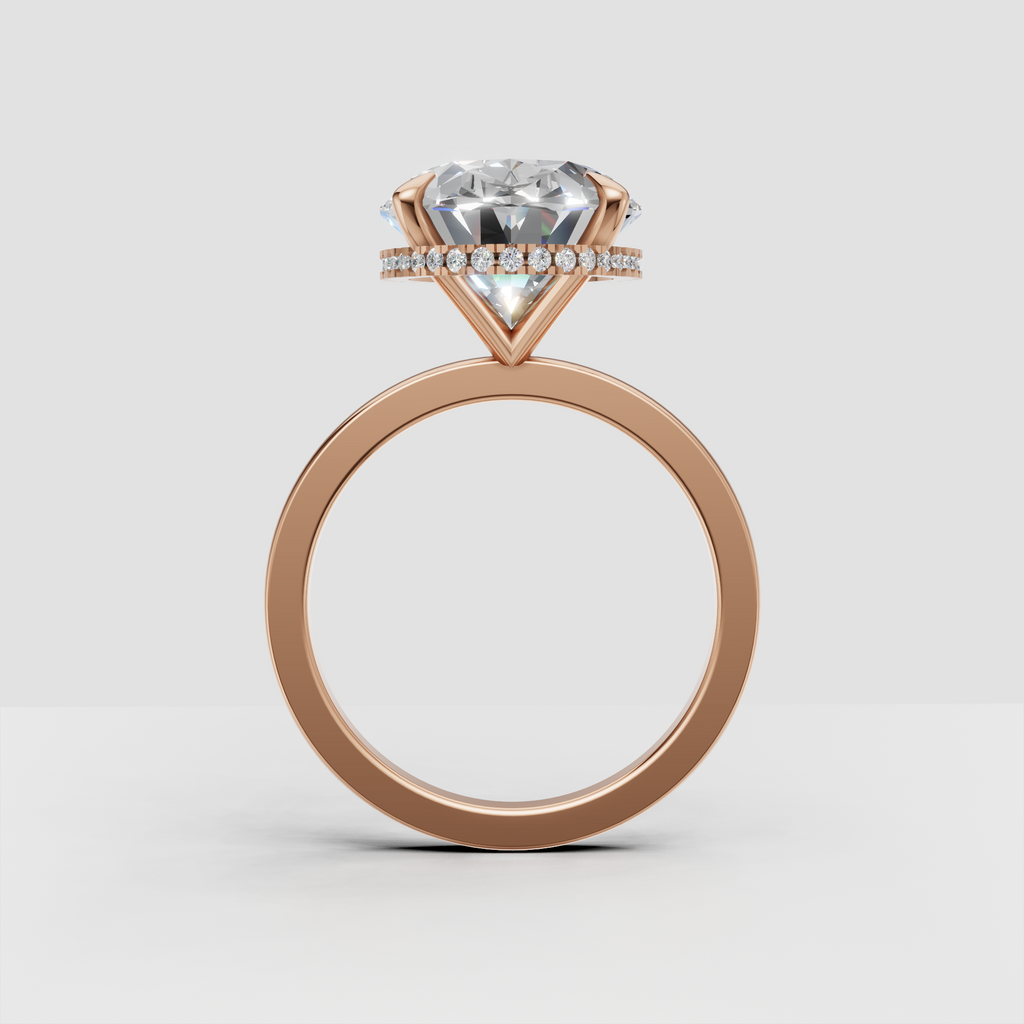 Polished gold ring featuring an oval cut diamond and hidden halo