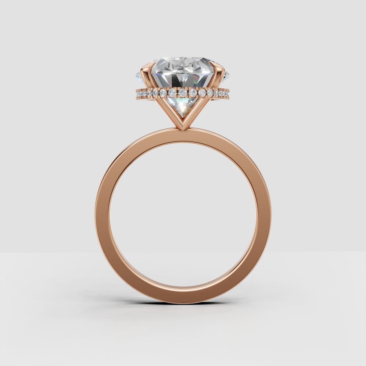Polished gold ring featuring an oval cut diamond and hidden halo