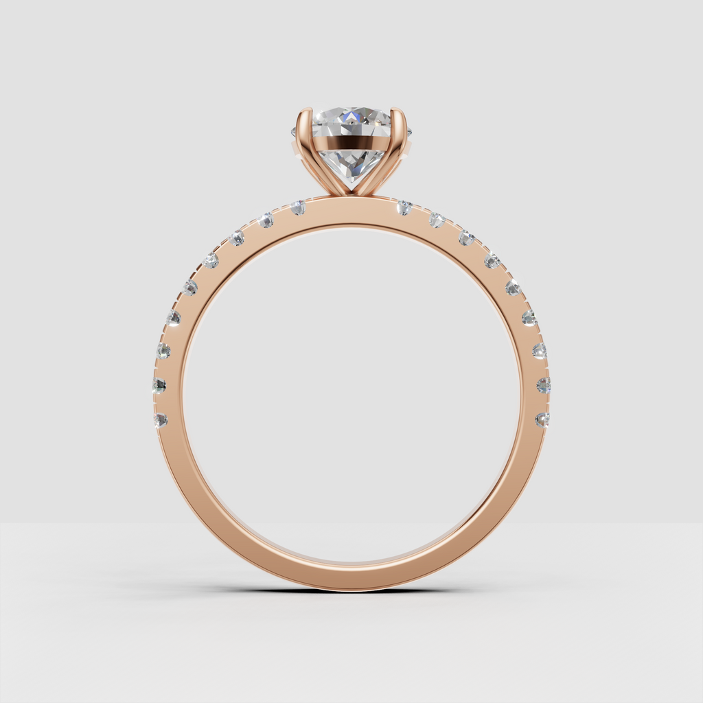 Delicate yellow gold engagement ring with round cut center stone