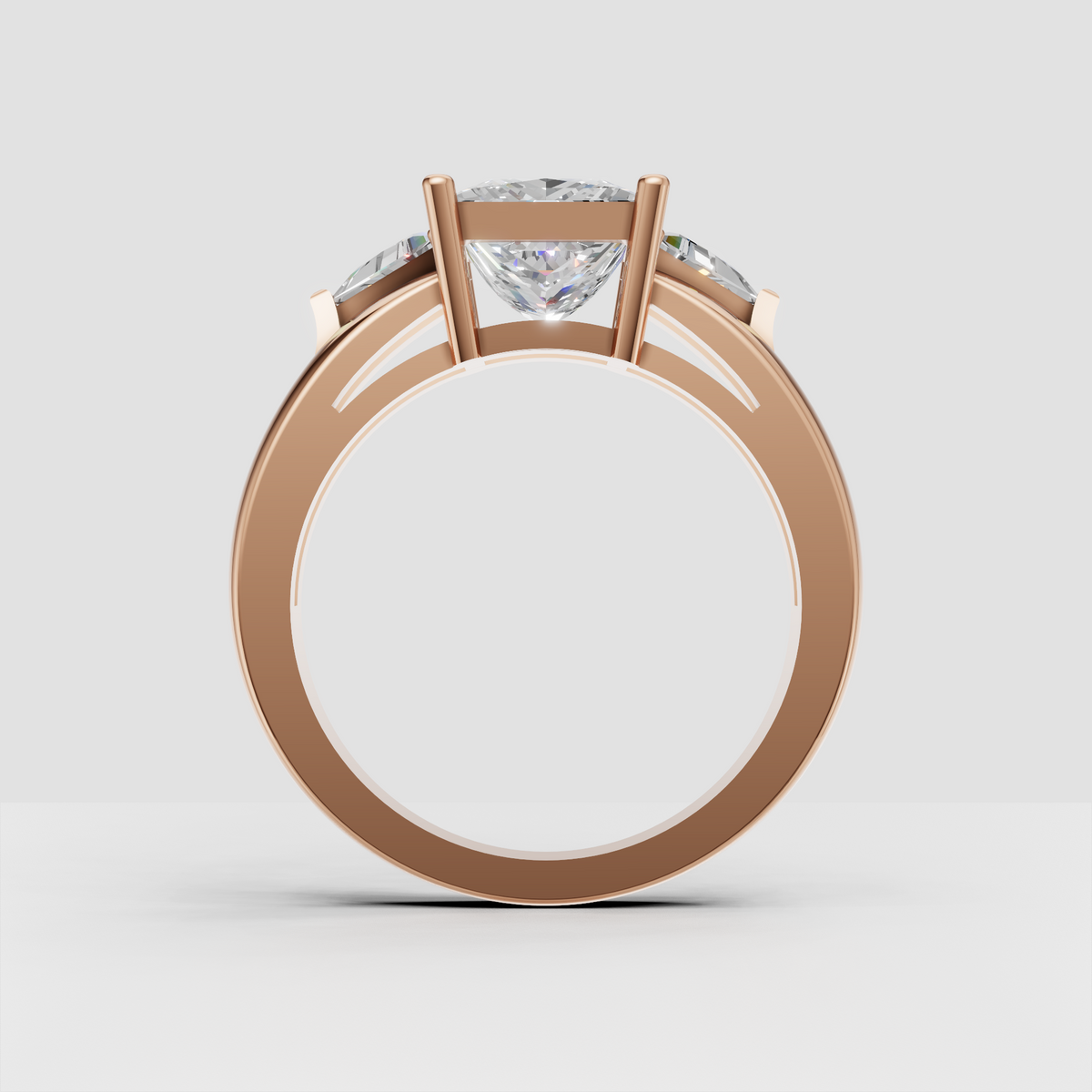 Perspective view of yellow gold three stone princess engagement ring