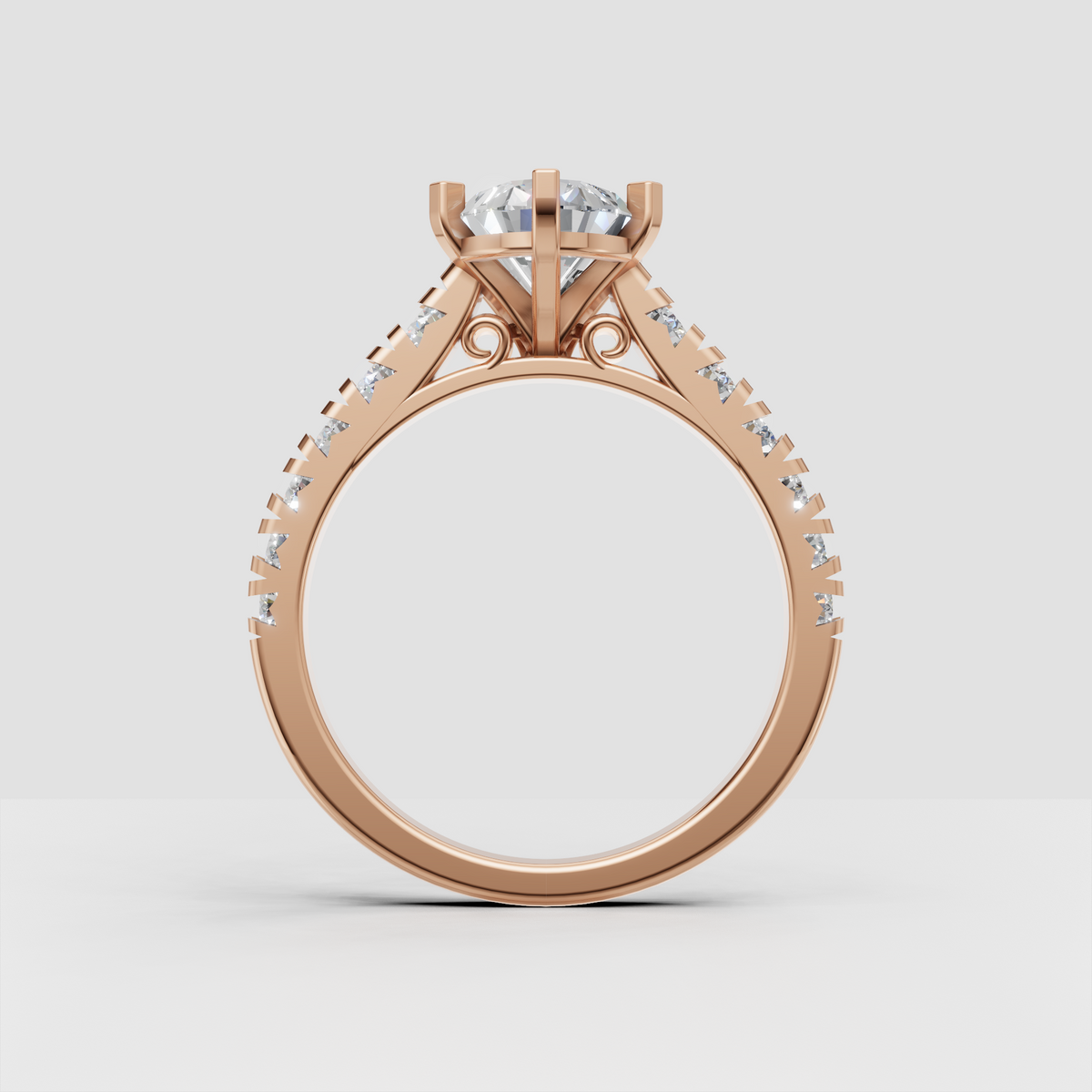 Pear shaped diamond engagement ring in yellow gold with symmetrical sparkling stones along both shoulders.