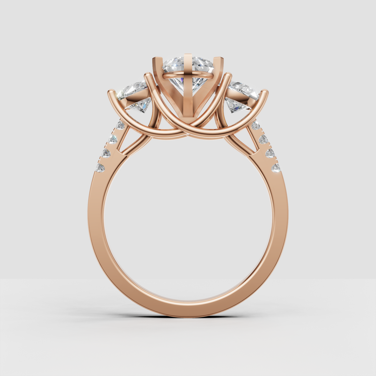 Pear shape diamond ring with round side diamonds and elevated gallery