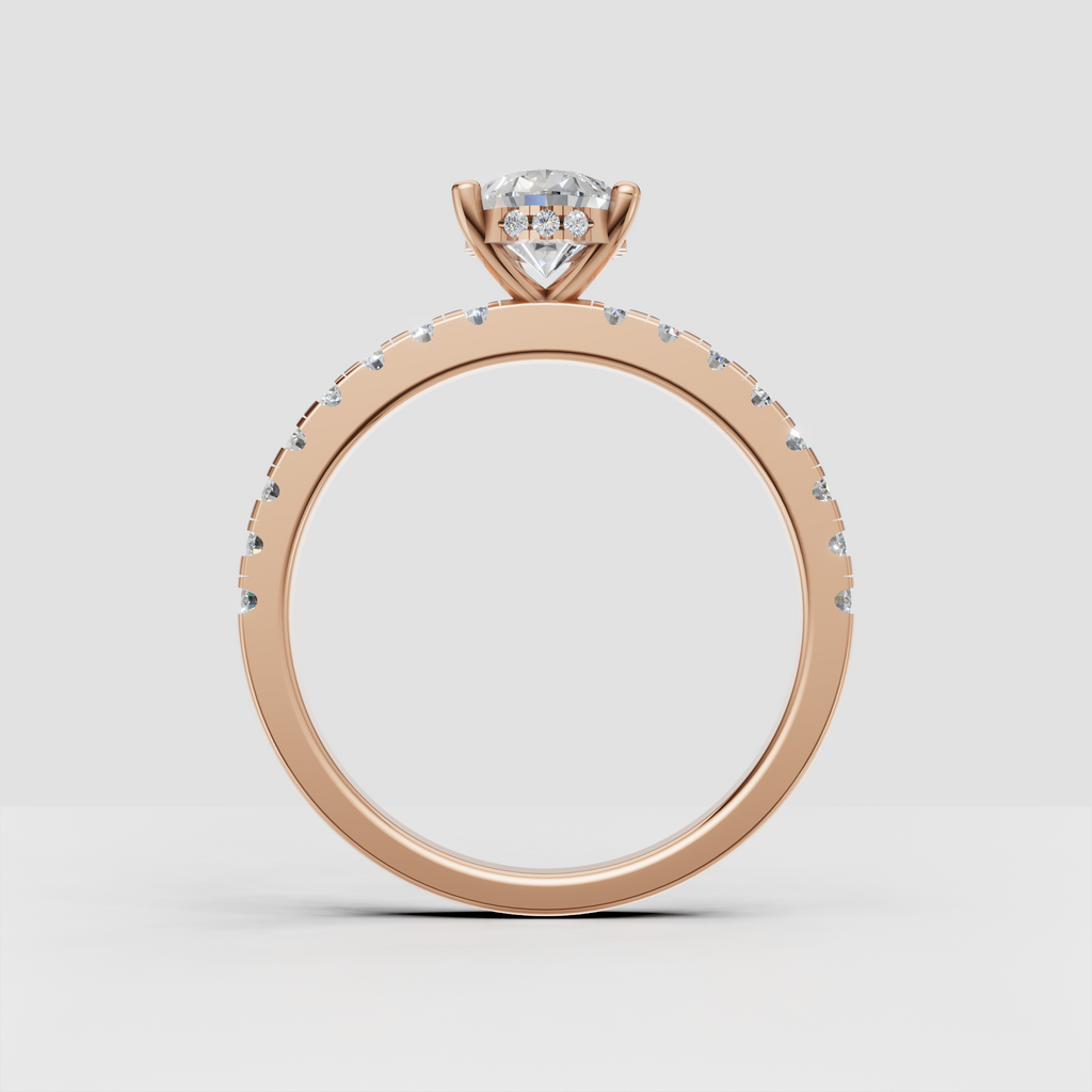 Pear diamond ring with four-prong setting and pavé shoulder stones