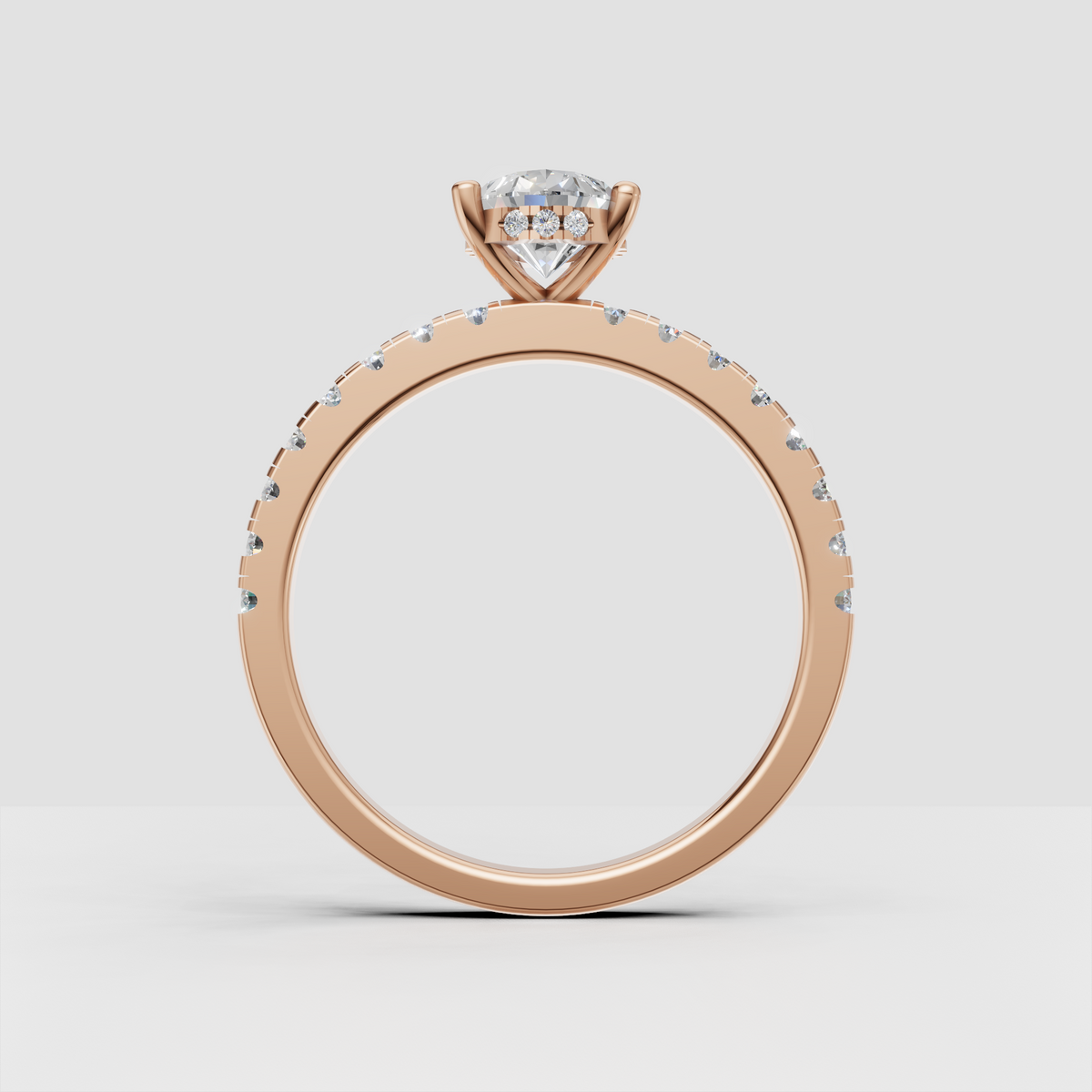 Pear diamond ring with four-prong setting and pavé shoulder stones