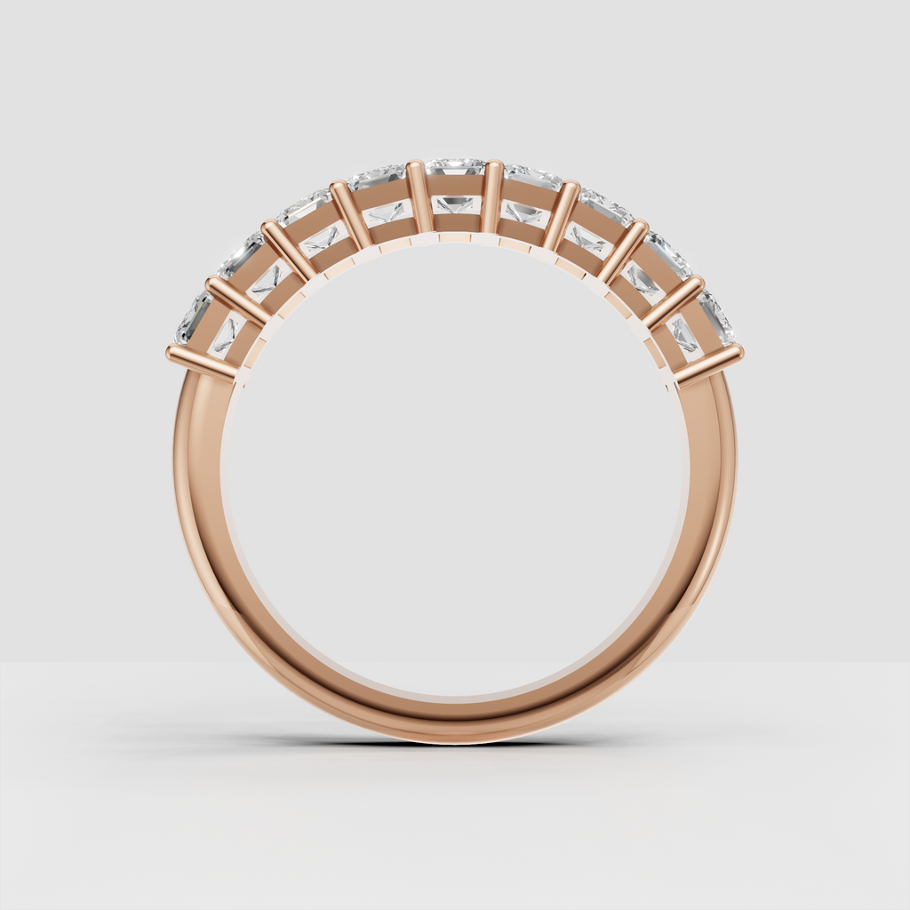 Luxury yellow gold eternity band with emerald cut stones