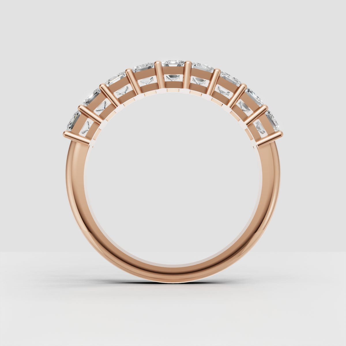 Luxury yellow gold eternity band with emerald cut stones