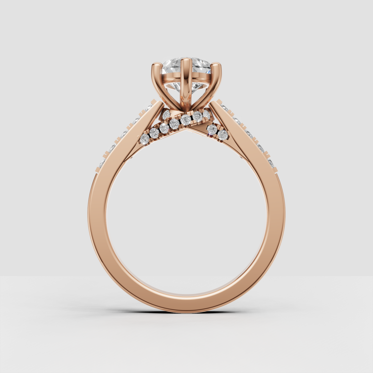 Pear shaped center diamond engagement ring with pavé-style round diamond accents