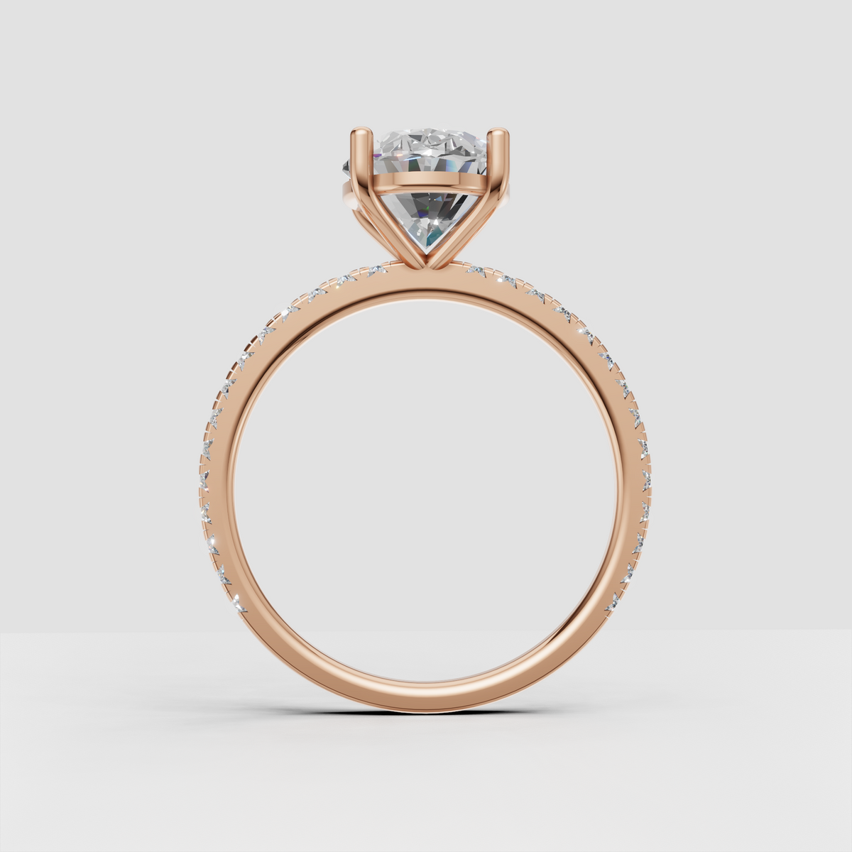 Detailed oval engagement ring with pavé-set diamond shoulders