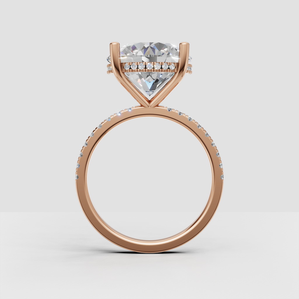 Sophisticated round brilliant engagement ring with hidden halo and continuous pavé detailing along the band.