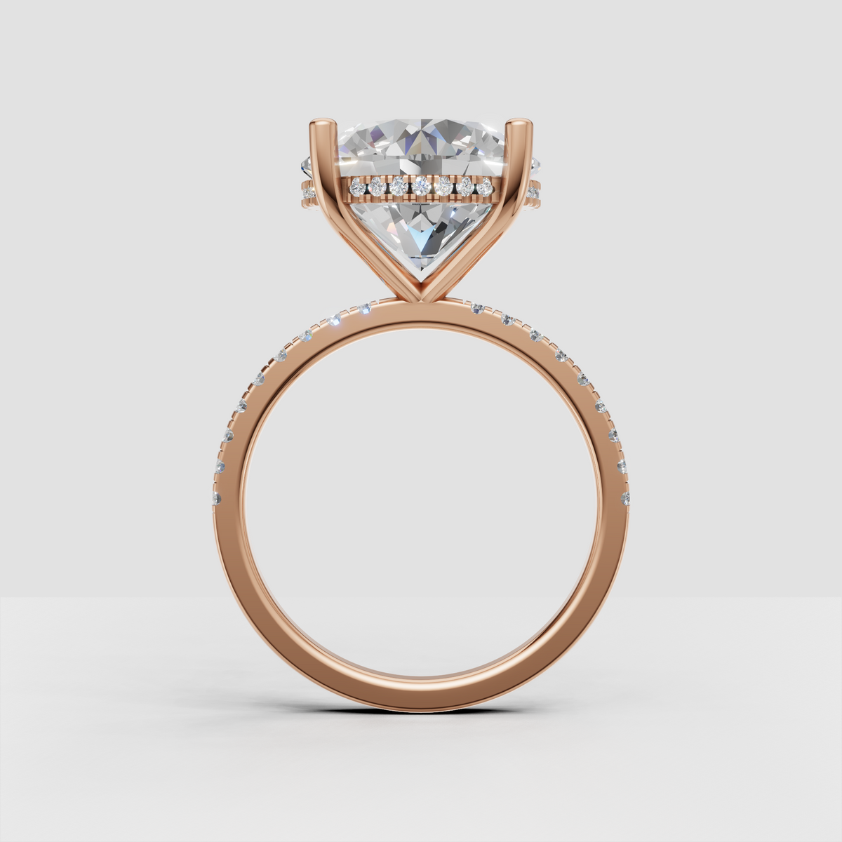 Sophisticated round brilliant engagement ring with hidden halo and continuous pavé detailing along the band.