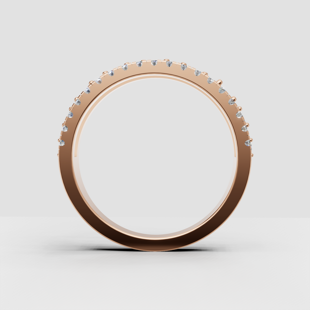 Side view of a wide yellow gold diamond band with intricate detailing