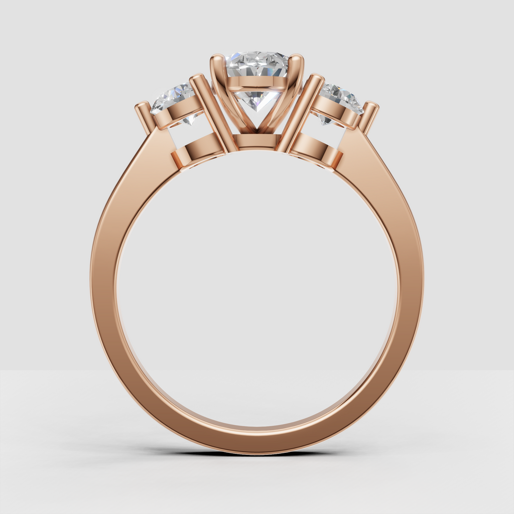 Oval center diamond with two round side stones in yellow gold