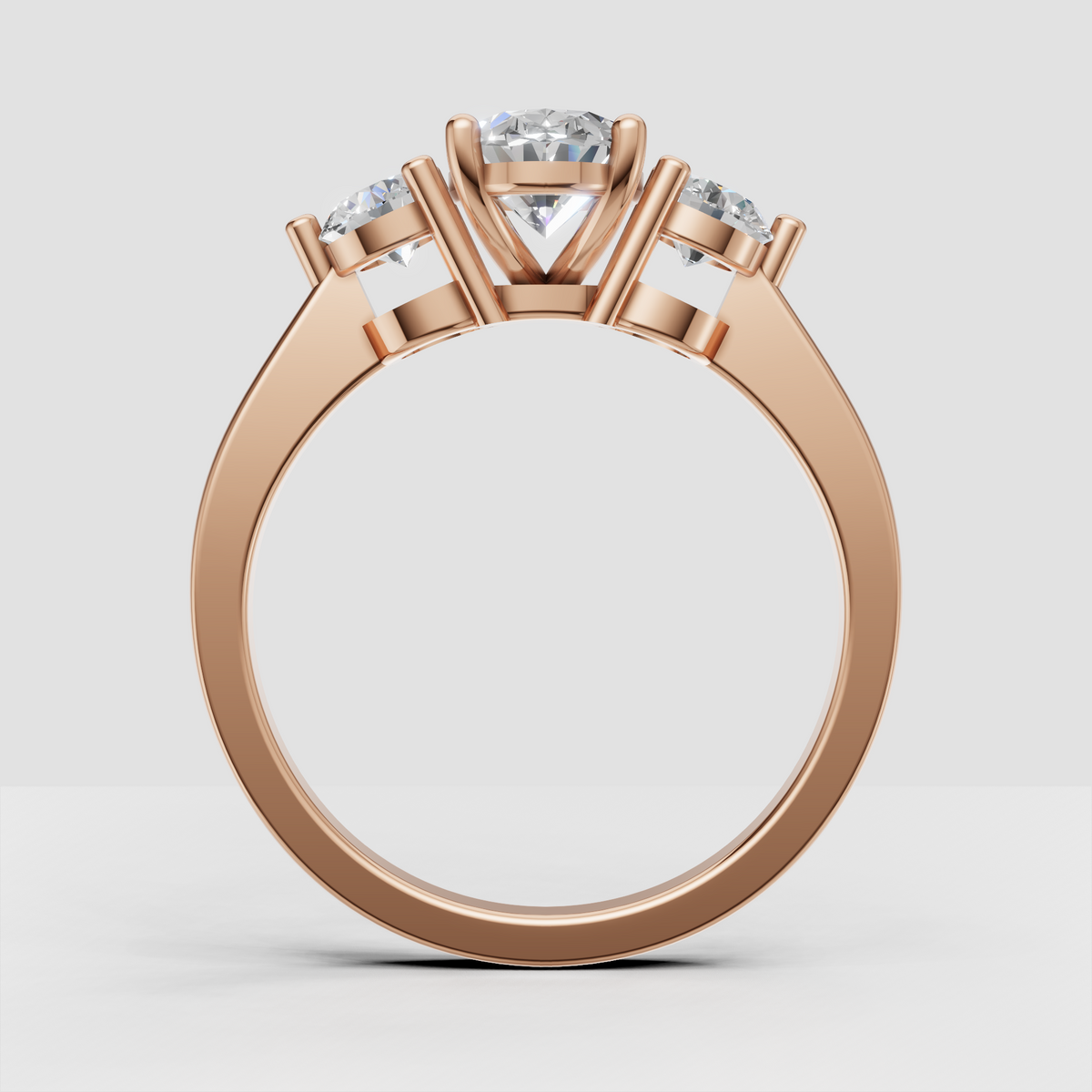 Oval center diamond with two round side stones in yellow gold