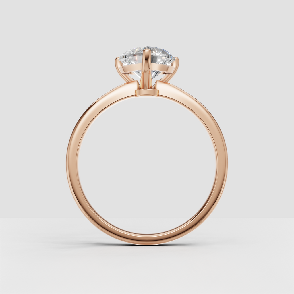 Close-up heart cut diamond engagement ring with three protective prongs