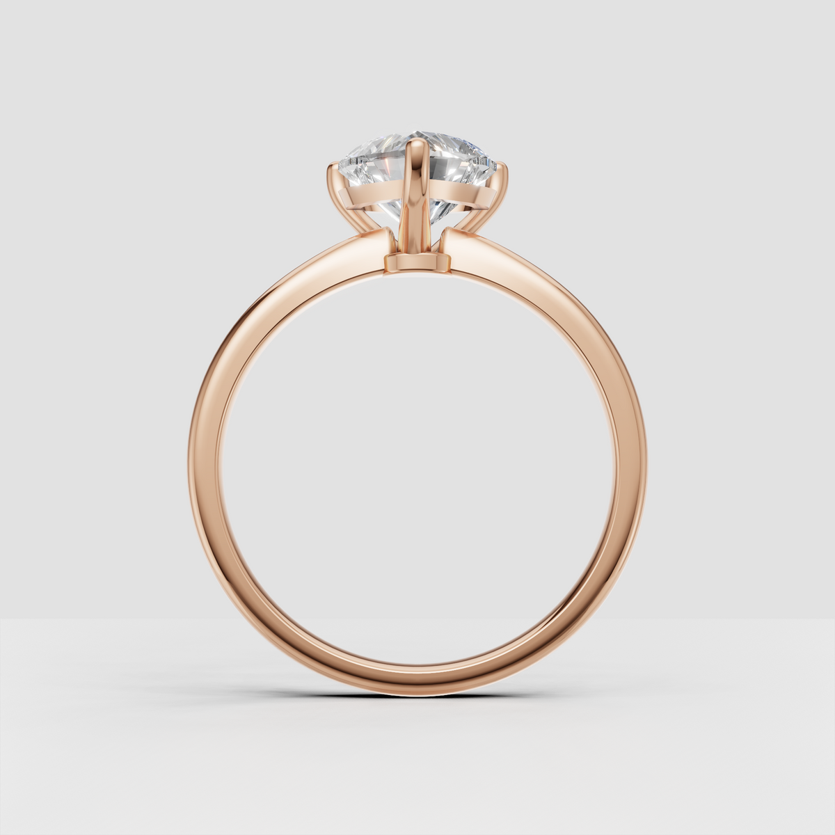 Close-up heart cut diamond engagement ring with three protective prongs