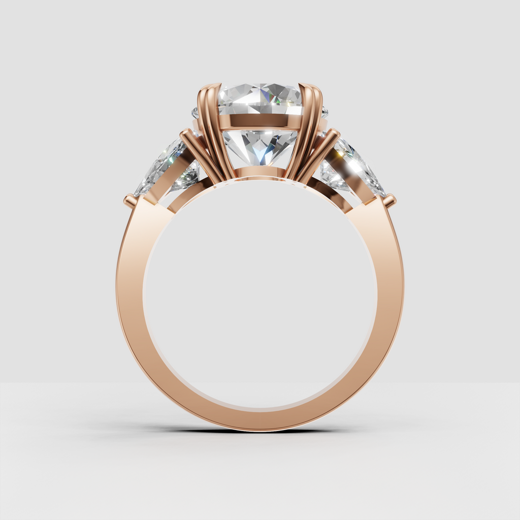 Three stone round diamond ring with polished yellow gold band and pear accents