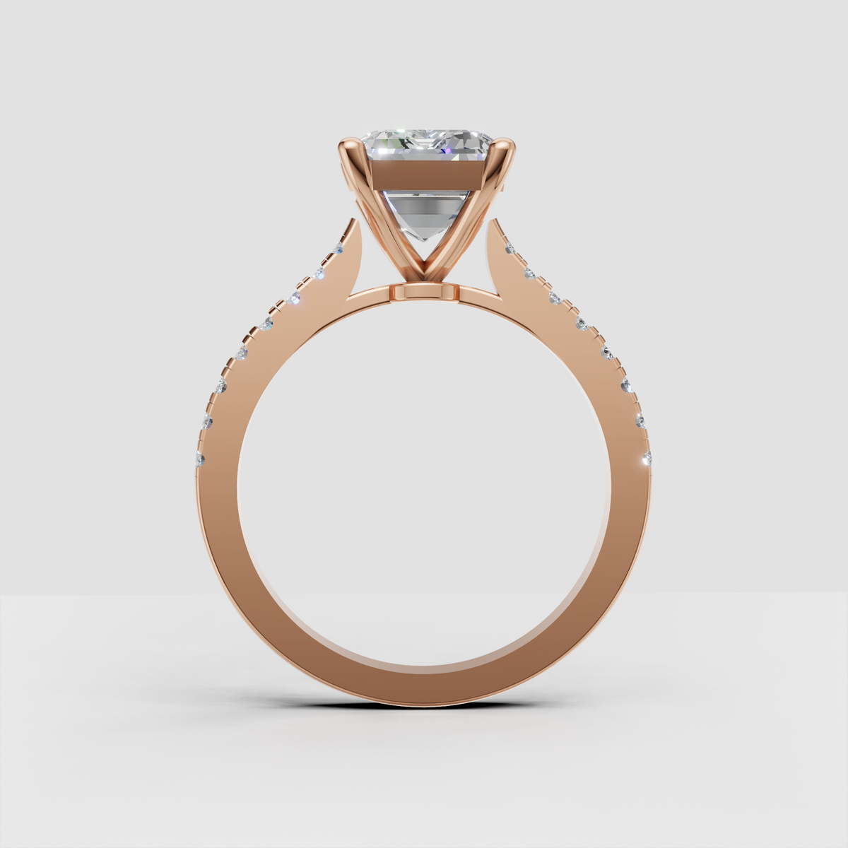 Yellow gold emerald engagement ring with delicate pavé diamonds