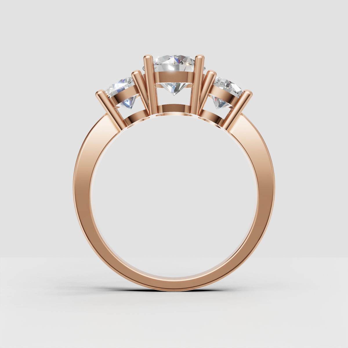 Classic yellow gold engagement ring with three round stones