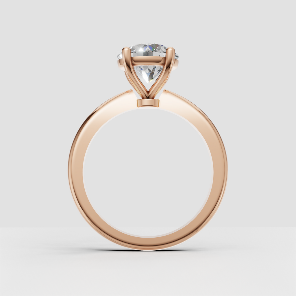 Elegant four-prong solitaire ring with round diamond and yellow gold band
