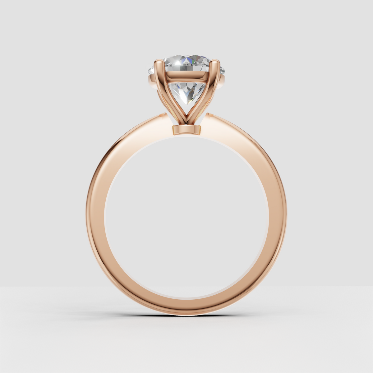 Elegant four-prong solitaire ring with round diamond and yellow gold band