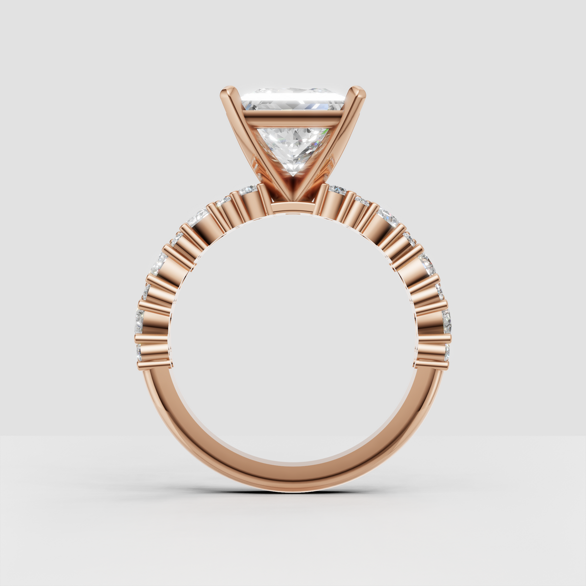 Side view of princess cut diamond engagement ring with detailed stone shoulders
