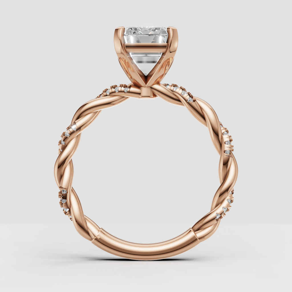 Emerald cut diamond ring with scattered pavé stones along twisted shoulders
