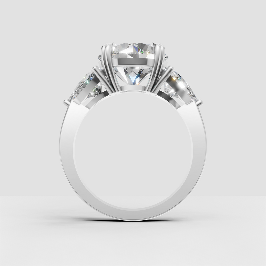 Elegant three stone engagement ring with round center diamond and pear accents
