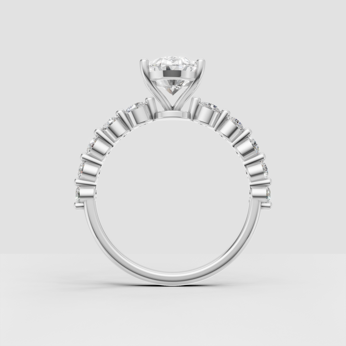 Yellow gold oval engagement ring featuring a brilliant center stone and side diamonds