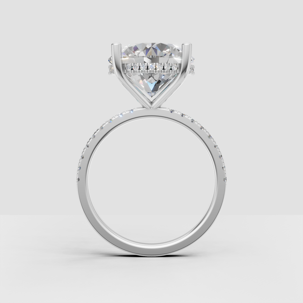 Round cut diamond engagement ring with brilliant center stone, hidden halo, and polished gold shank.