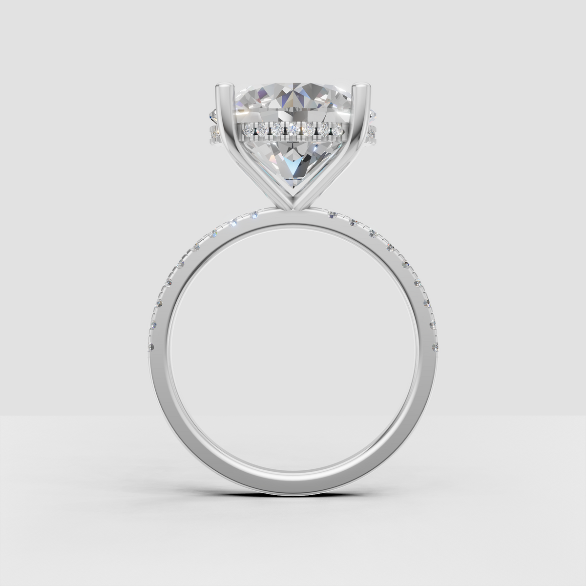 Round cut diamond engagement ring with brilliant center stone, hidden halo, and polished gold shank.