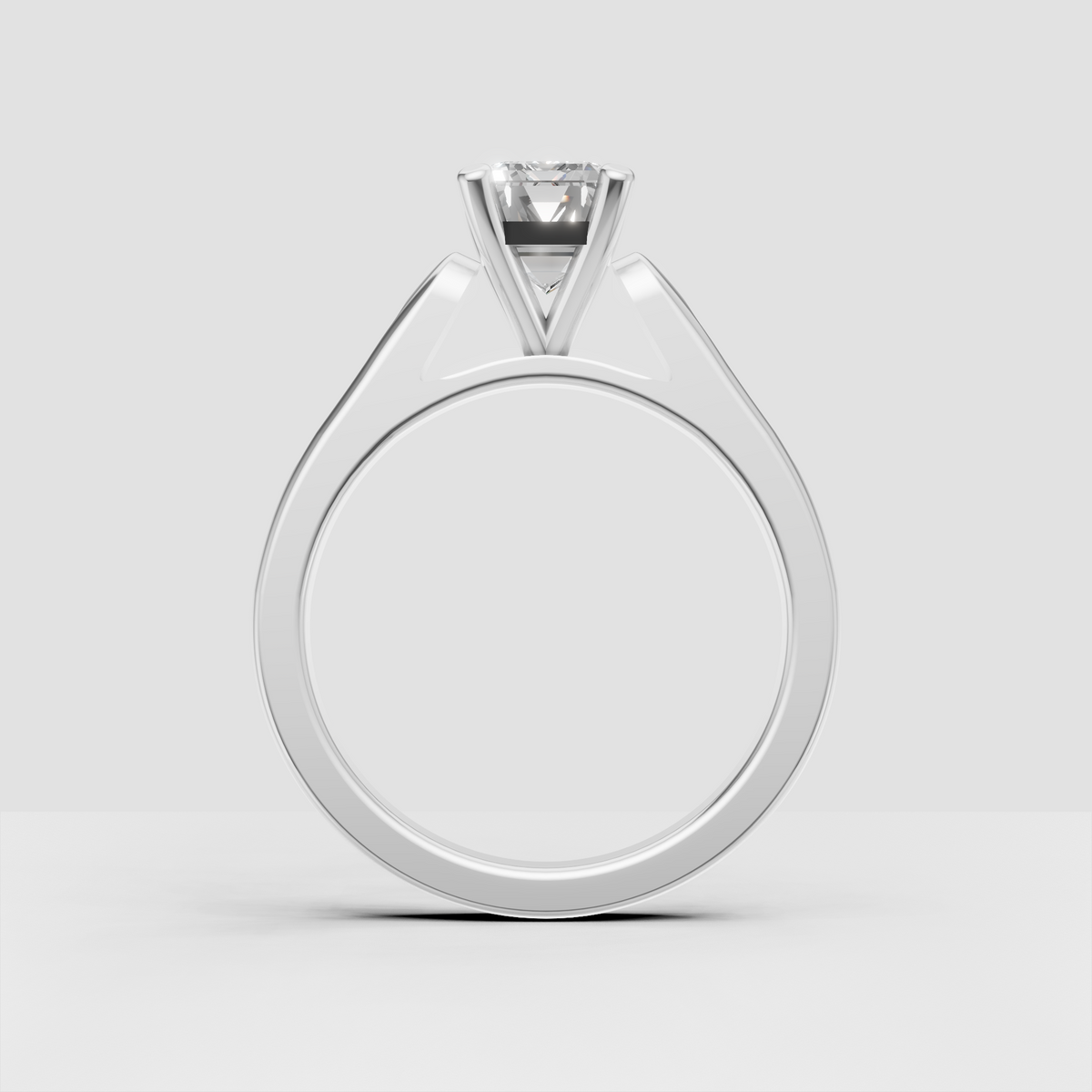 Yellow gold emerald solitaire ring with round accent stones.